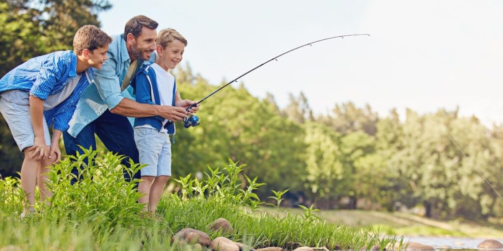 Family enjoying fishing adventure, scenic nature walk, and relaxing evening bonfire as part of a fun-filled outdoor holiday package.