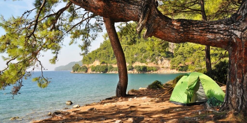 Travelers exploring hidden natural gems and camping by the riverside, enjoying scenic views and outdoor adventure.