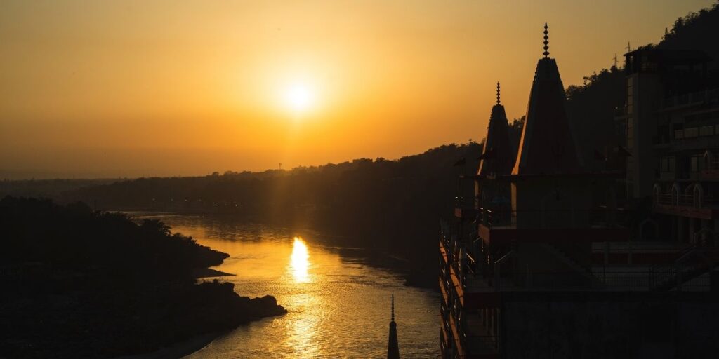 Relaxing riverside spa treatments, group yoga sessions, and stunning sunset views at a serene wellness retreat.