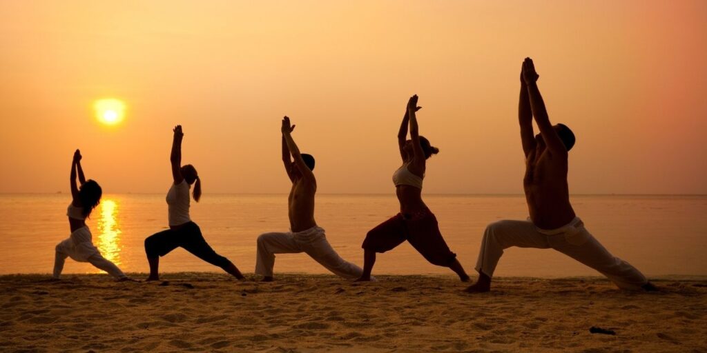 Multi-generation family enjoying camping in nature, fishing by the river, and group yoga sessions for relaxation and bonding.
