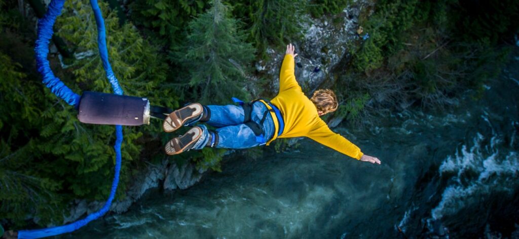 Adventurer enjoying a thrilling bungee jump at Ganga Beach Camp in Rishikesh, offering exciting outdoor activities, scenic views, and adrenaline-filled experiences.